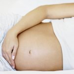 Pregnant woman with exposed belly