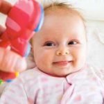 baby looking at a toy
