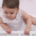 The baby is not sleeping and wants to get out of the crib