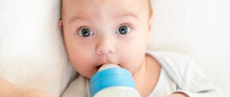 Baby drinks from a bottle