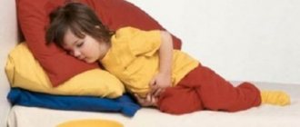The child lies holding his stomach