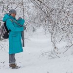 Woman walking with newborn in winter