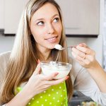 Woman eating cottage cheese