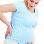 Woman in position holding her lower back